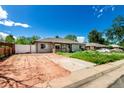 Charming single-story home with an unfinished front yard and a white fence at 1151 Revere St, Aurora, CO 80011