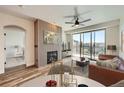 Bright living room featuring a modern fireplace, a ceiling fan, and a sliding door to a balcony at 9079 E Panorama Cir # 419, Englewood, CO 80112