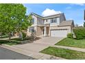 Charming two-story home with brick accents, a well-manicured lawn, and a two-car garage at 1160 S Fultondale Ct, Aurora, CO 80018