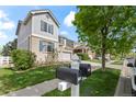 Lovely two-story house with brick accents and shuttered windows, situated on a well-manicured lawn at 1160 S Fultondale Ct, Aurora, CO 80018