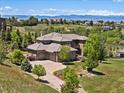 Sprawling home with a three-car garage, beautiful landscaping, and mountain views in the distance at 6995 S Ensenada St, Aurora, CO 80016