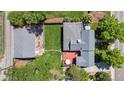 Aerial view of a home with a spacious backyard, deck, detached garage, and mature trees at 2311 W 46Th Ave, Denver, CO 80211