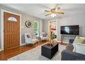 Inviting living room with hardwood floors, lots of natural light, and a relaxed seating arrangement at 2311 W 46Th Ave, Denver, CO 80211