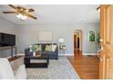 Cozy living room with hardwood floors, neutral walls, ceiling fan, and comfortable seating area at 2311 W 46Th Ave, Denver, CO 80211