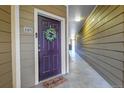 Inviting entryway featuring a decorative door with a wreath and a 'welcome' mat at 17442 Nature Walk Trl # 105, Parker, CO 80134