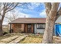 Charming home with brick and siding exterior, screened porch, and unique brick walkway leading to the front door at 4493 Elkhart St, Denver, CO 80239