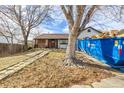 Charming home featuring a unique brick walkway leading to the front porch and a blue dumpster in the driveway at 4493 Elkhart St, Denver, CO 80239