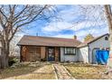 Charming home with brick and siding exterior, screened porch, and unique brick walkway leading to the front door at 4493 Elkhart St, Denver, CO 80239