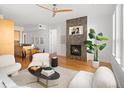 Bright living room features a fireplace, hardwood floors, and stylish contemporary furnishings at 340 S Lafayette St # 201, Denver, CO 80209