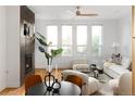 Sun-filled living room showcasing bright white walls, hardwood floors, and a modern fireplace at 340 S Lafayette St # 201, Denver, CO 80209