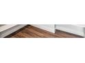 Close up of elegant wood flooring with white baseboards and trim at 1699 Morgan Dr, Erie, CO 80516