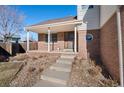 Charming front porch with brick accents and a cozy entrance, perfect for welcoming guests at 2875 E 124Th Way, Thornton, CO 80241