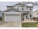 Inviting two-story home with neutral siding, stone accents, and an attached two-car garage at 11746 Elizabeth Cir, Thornton, CO 80233
