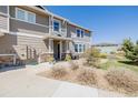 Inviting townhome exterior showcasing a charming entryway, manicured landscaping, and a well-lit walkway at 9047 Apache Plume Dr # D, Parker, CO 80134