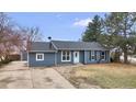 Cozy single-story home with updated siding, landscaping, and a well-manicured front yard at 6680 E Rustic Dr, Parker, CO 80138