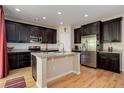 Beautiful kitchen with stainless steel appliances, granite countertops, and dark wood cabinetry at 12513 Grape St, Thornton, CO 80241