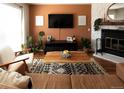 Cozy living room with modern decor, a brick fireplace, and a comfortable seating area at 19738 Applewood Ct, Parker, CO 80138