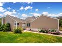 Beautiful house with vibrant green lawn and colorful flowers by the sidewalk at 535 High Point Dr, Golden, CO 80403