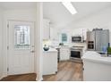 Bright kitchen with stainless steel appliances, stylish lighting and tile backsplash at 535 High Point Dr, Golden, CO 80403
