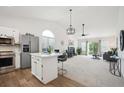 Open floor plan with modern kitchen island and living room at 535 High Point Dr, Golden, CO 80403