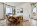 Elegant dining area features a large wood table, seating for eight, and ample natural light at 8733 Arriba Dr, Littleton, CO 80125