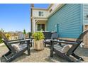 Cozy backyard patio features comfortable seating and a fire pit, perfect for outdoor entertaining at 8733 Arriba Dr, Littleton, CO 80125