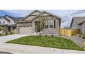 Charming single-Gathering home featuring a stone facade and a two-car garage with modern doors at 15376 Ivanhoe Ct, Thornton, CO 80602