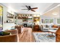 Open living room with hardwood floors, a wood-burning fireplace, and stylish decor at 4986 White House Trl, Evergreen, CO 80439