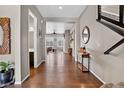 Inviting hallway with hardwood floors and an open view to the living room at 436 Sage Grouse Cir, Castle Rock, CO 80109