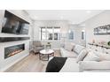 Inviting living area with sleek fireplace, large TV, comfortable seating, and natural light at 6792 Navajo Way, Denver, CO 80221