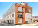 Modern townhome featuring three stories, balconies, and attached garages, showcasing contemporary architectural design at 1822 Grove St # 110, Denver, CO 80204