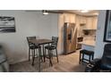 A bright kitchen and cozy breakfast nook boasts updated appliances and fixtures at 795 S Alton Way # 4C, Denver, CO 80247