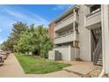 Apartment building with multiple balconies, lush landscaping, and ample parking available at 14214 E 1St Dr # B08, Aurora, CO 80011