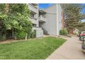 Building exterior showcases neat landscaping, green lawn, and well-maintained surroundings at 14214 E 1St Dr # B08, Aurora, CO 80011