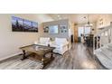 Inviting living room with wood floors, comfortable seating, and stylish decor at 3268 E 136Th Pl, Thornton, CO 80602