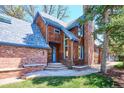Attractive home with wood siding and a brick facade, complemented by steps leading to the front door at 2504 S Garfield St, Denver, CO 80210