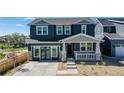 Two-story home with gray siding, stone accents, and a covered porch at 2980 E 102Nd Pl, Thornton, CO 80229