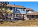 Beautiful townhouse with blue accents, brick facade, and cozy seating on the front porch at 2540 E Geddes Pl, Centennial, CO 80122