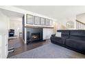 Inviting living room with a cozy fireplace and decorative map prints at 2540 E Geddes Pl, Centennial, CO 80122