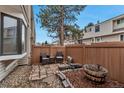 Private patio area with a seating arrangement and plant containers, creating a relaxing outdoor space for leisure and gardening at 4206 E Maplewood Way, Centennial, CO 80121