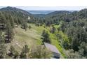 Aerial view showcasing the property's serene mountain setting and forested surroundings at 100 Wildcat Ln, Boulder, CO 80304