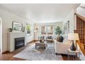 Bright living room with fireplace, large windows, and hardwood floors at 1109 Jersey St, Denver, CO 80220