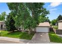 Charming two-story home with an attached garage and well-maintained lawn in a desirable neighborhood at 9196 W Maplewood Ave, Littleton, CO 80123