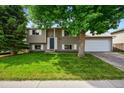 Charming two-story home with a well-maintained lawn and mature tree in a desirable neighborhood at 9196 W Maplewood Ave, Littleton, CO 80123