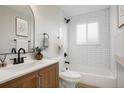Updated bathroom featuring subway tile, modern fixtures, and a clean design at 14544 March Dr, Denver, CO 80239