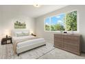 Bright bedroom featuring a large window and neutral décor with stylish furniture at 14544 March Dr, Denver, CO 80239