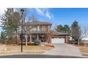 Attractive two-story home with brick detailing, an attached garage, and mature trees in a well-kept neighborhood at 4495 Rainbow Ln, Broomfield, CO 80020