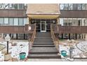 Building entrance showcasing grand staircase leading to the front doors with visible unit number at 6940 E Girard Ave # 210, Denver, CO 80224