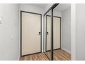 Hallway storage with sliding mirror doors and wood-look floors at 6940 E Girard Ave # 210, Denver, CO 80224