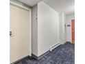 Hallway with unit number and door, showing access to the residential space at 6940 E Girard Ave # 210, Denver, CO 80224